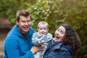 A joyful family moment captured outdoors in natural lighting.