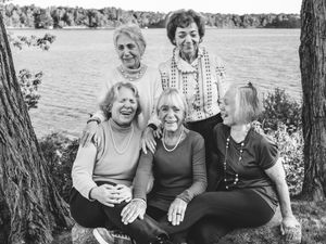 Five elderly sisters sit on a bench near the water in Brunswick, Maine.