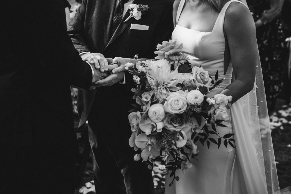 Wedding ceremony details with white floral arrangements and elegant decor.