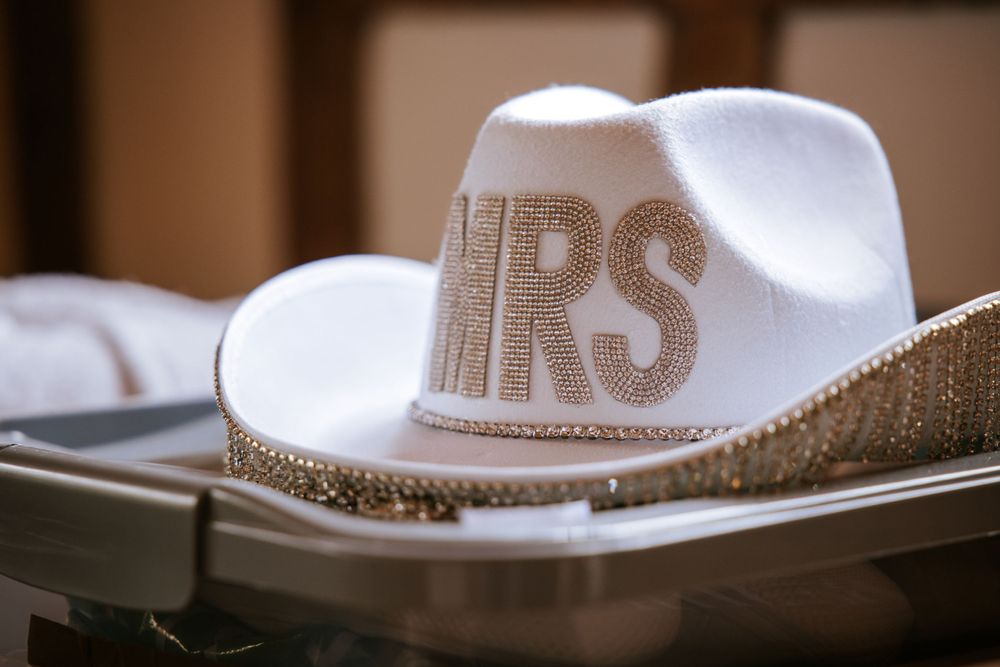 Hat with Mrs written on it lined up for wedding reception in Cain Manor in Hampshire.