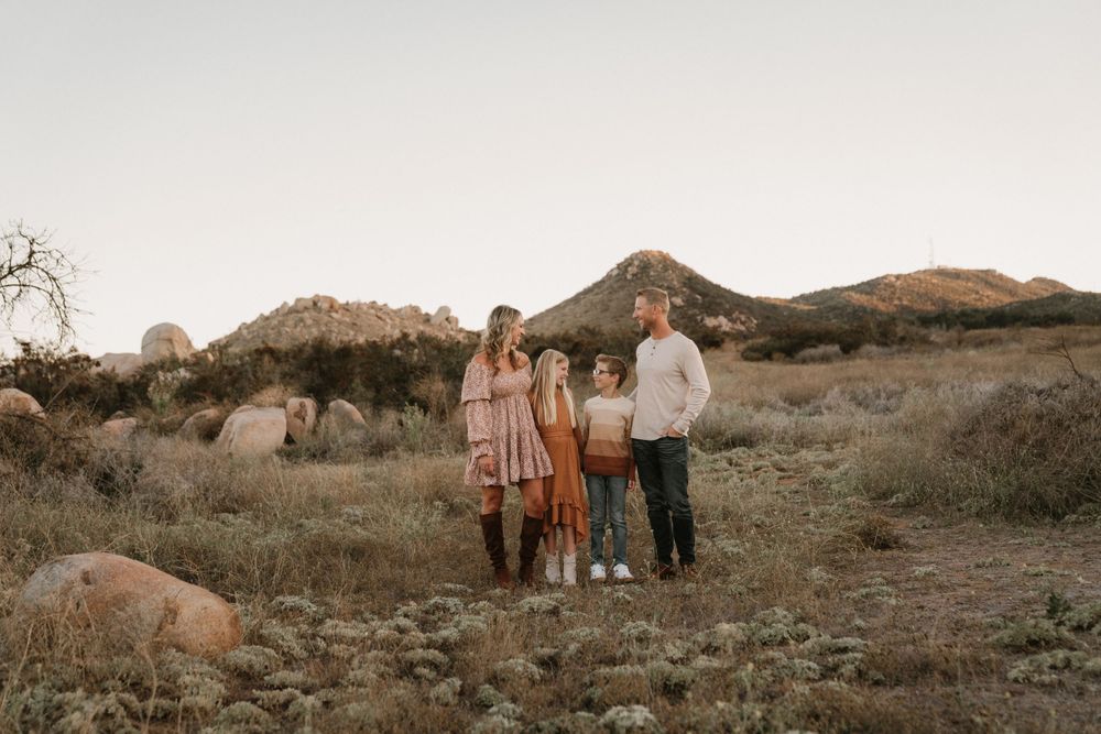Group portrait at sunset in a desert mountain landscape.
