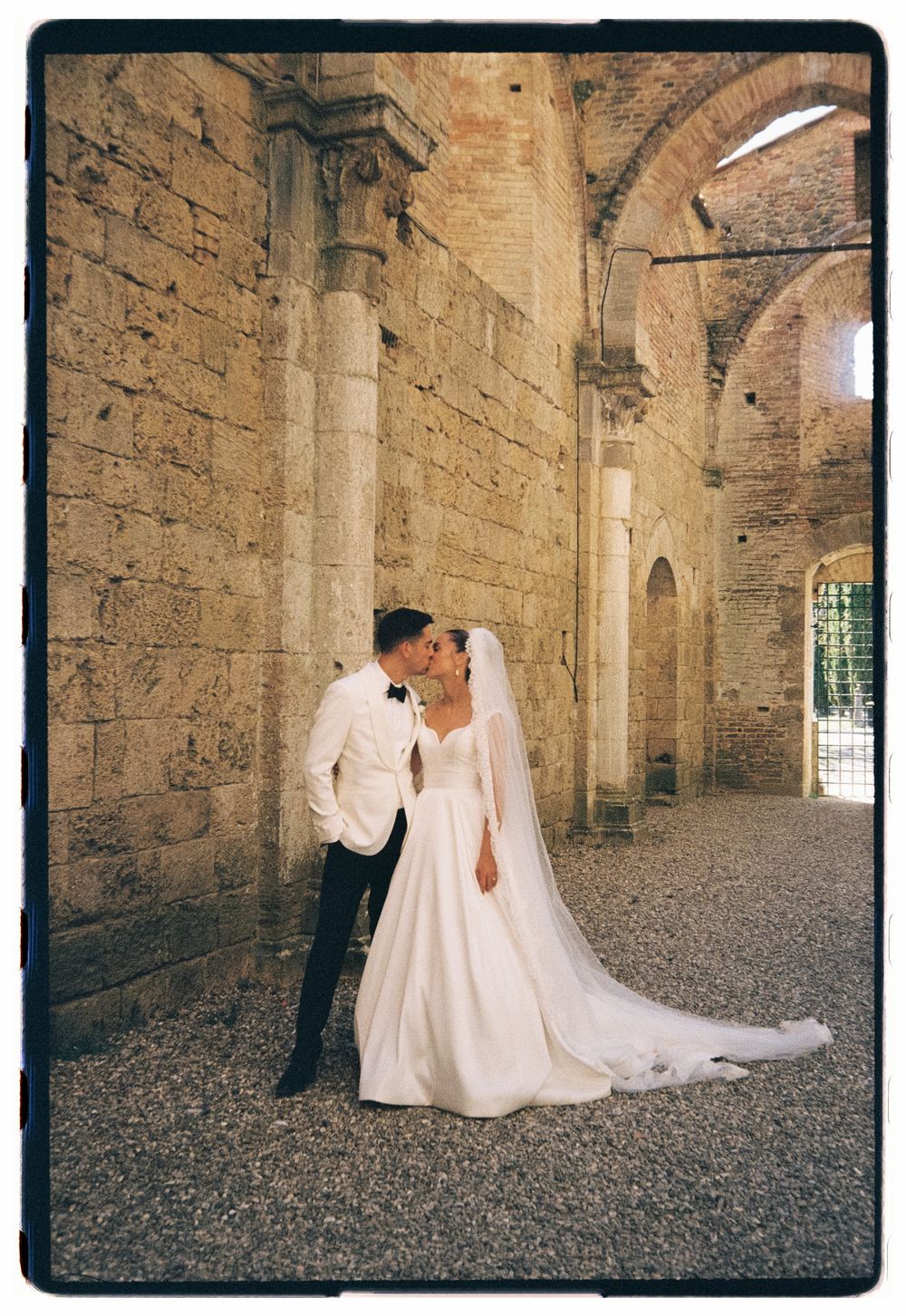 Happy American newlyweds outside a charming church by Lake Maggiore, Italy