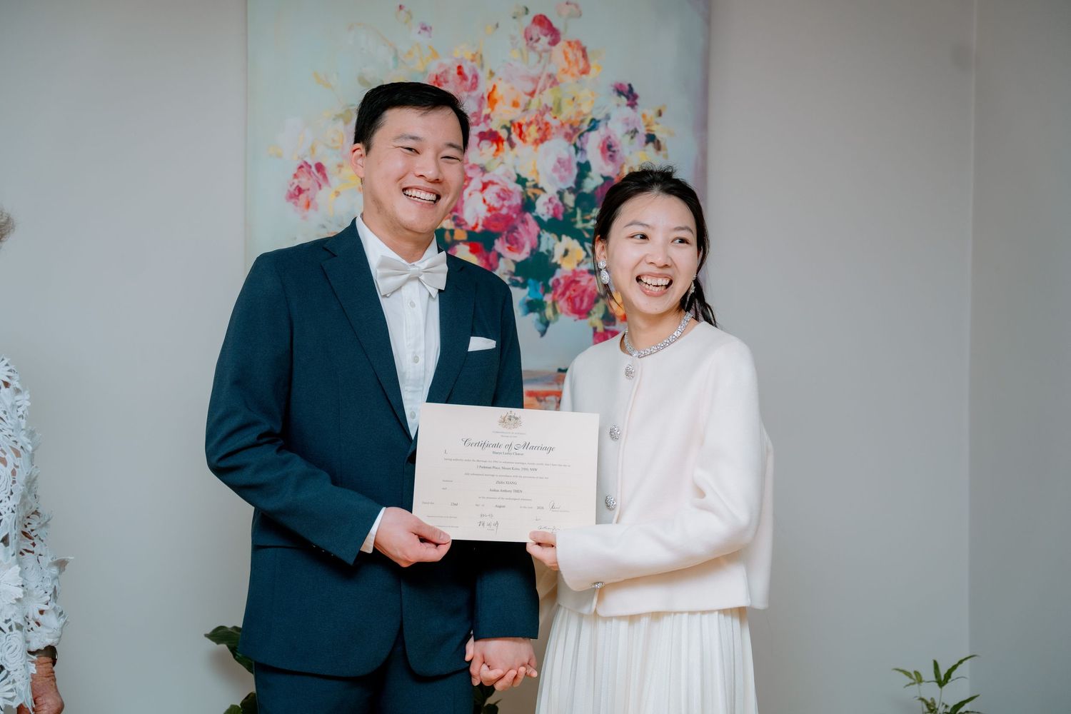 Smiling couple holding hands and showing their marriage certificate - just eloped, Sydney elopement photography