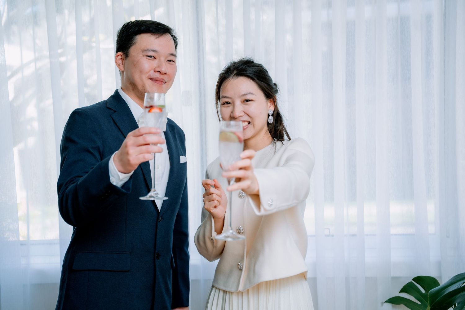 Couple raise champagne glasses in a celebratory toast - elopement celebration photography, Sydney