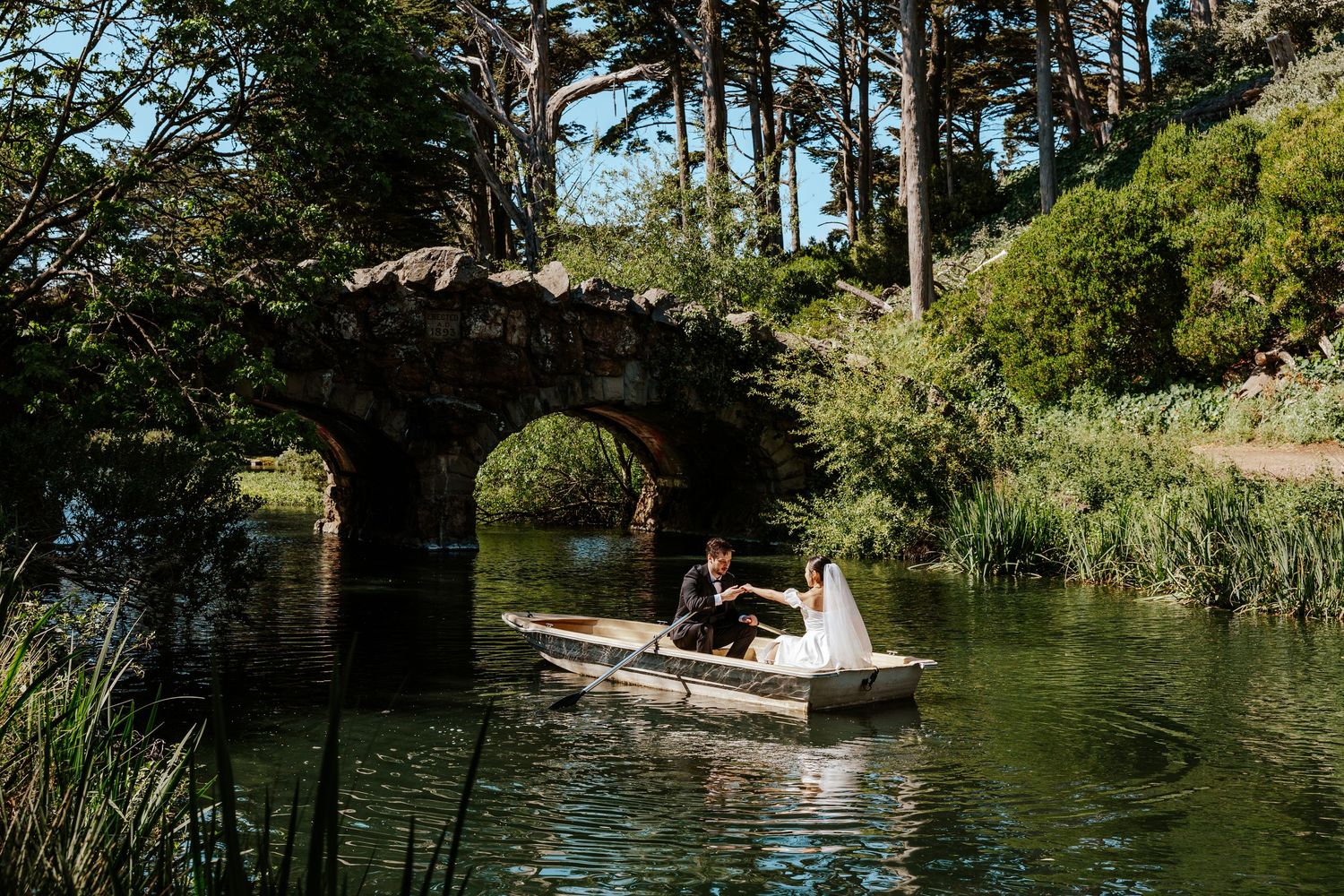 eloping couple in a row boat in golden gate park. san francisco bay area elopement photographer