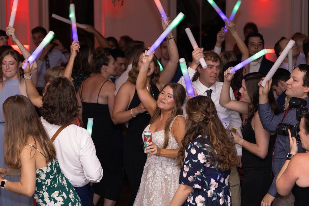 Bride dancing with guests at a lively wedding reception party in the Alcove Cincinnati wedding venue.
