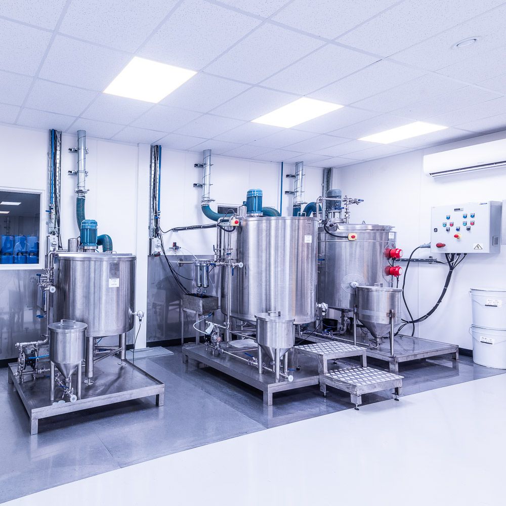 Industrial paint mixing room showing paint production machines