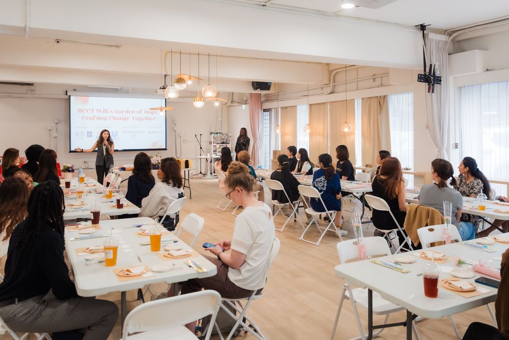 Women attending a professional workshop seminar in a modern bright meeting room with presentation screen.