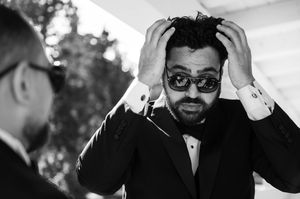 A series of black and white candid photos showing a person in sunglasses with various expressions and poses.