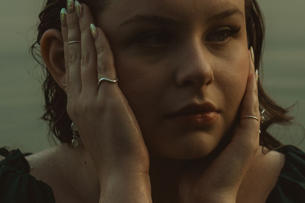 Ethereal senior portraits in Spokane featuring a water-filled outdoor session with cinematic composition and soft natural light.