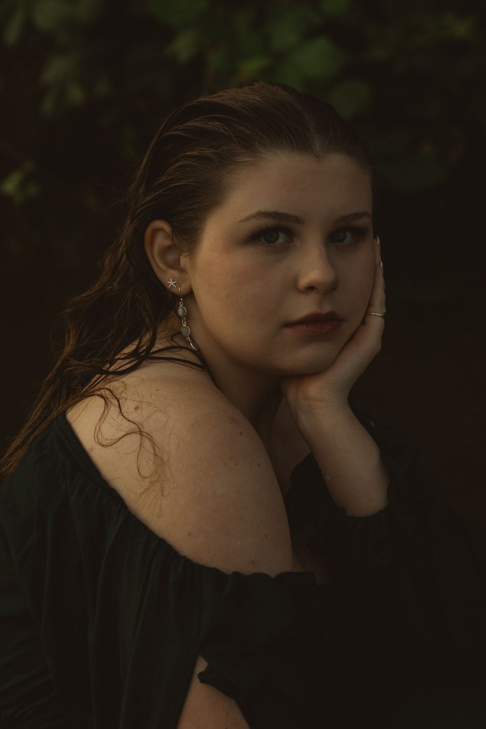 Spokane senior portraits with a cinematic water setting, capturing artistic poses and natural summer beauty.