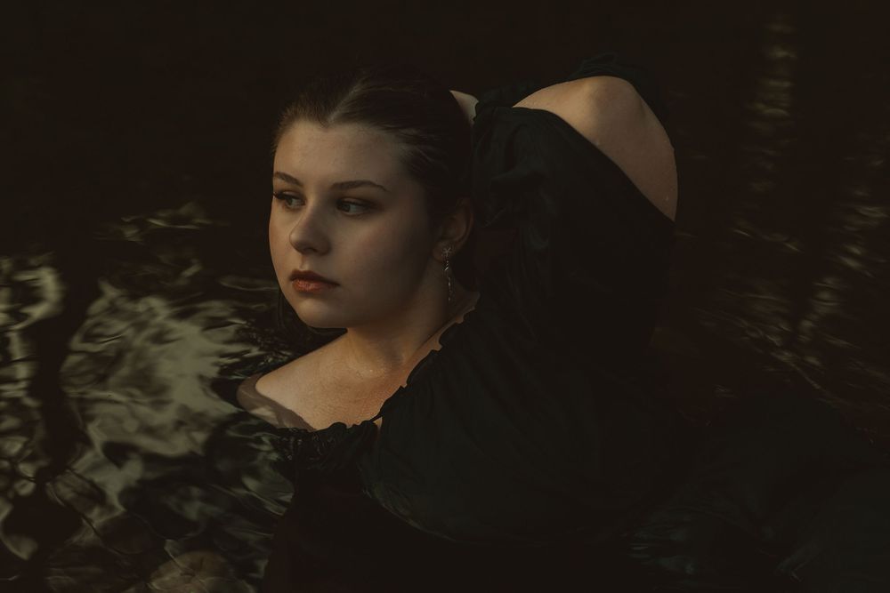 Spokane, WA senior photography featuring artistic portraits in the water with a dreamy, cinematic atmosphere.