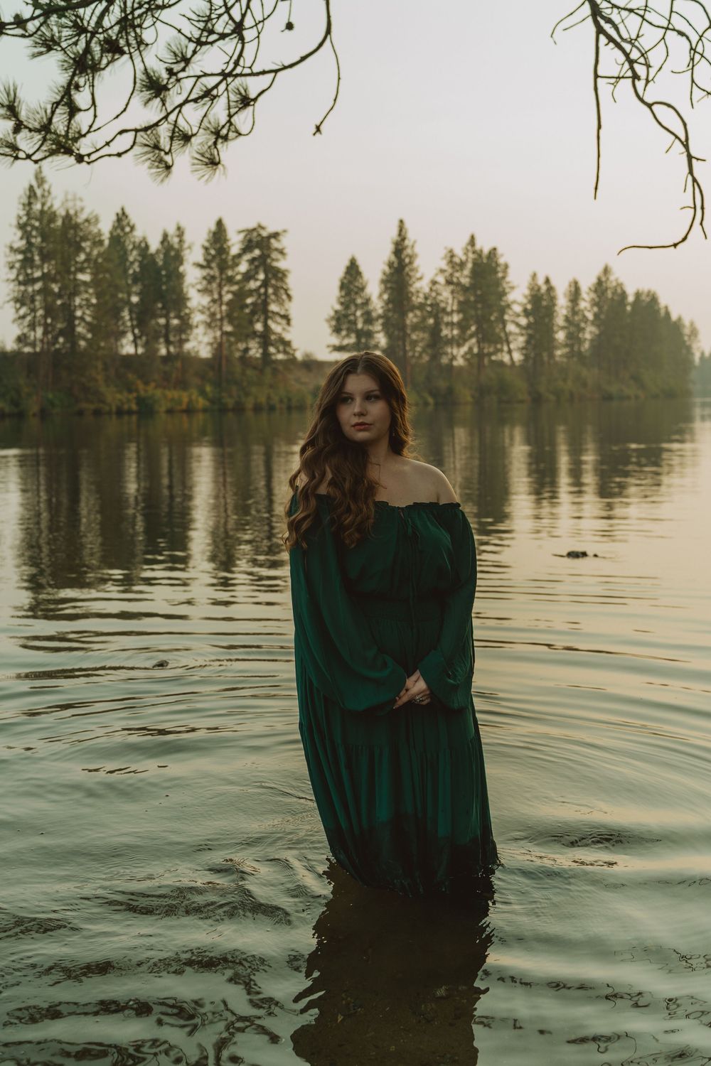Dreamy Spokane senior portraits captured outdoors with a scenic waterfront backdrop and cinematic atmosphere.