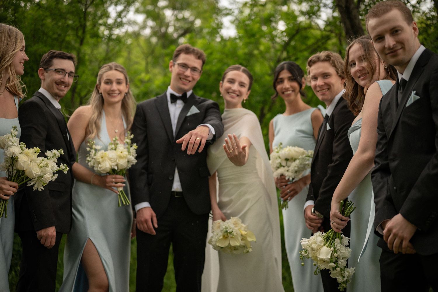 Trendy blurred shot of a wedding party walking around a couple, captured in warm fall tones.