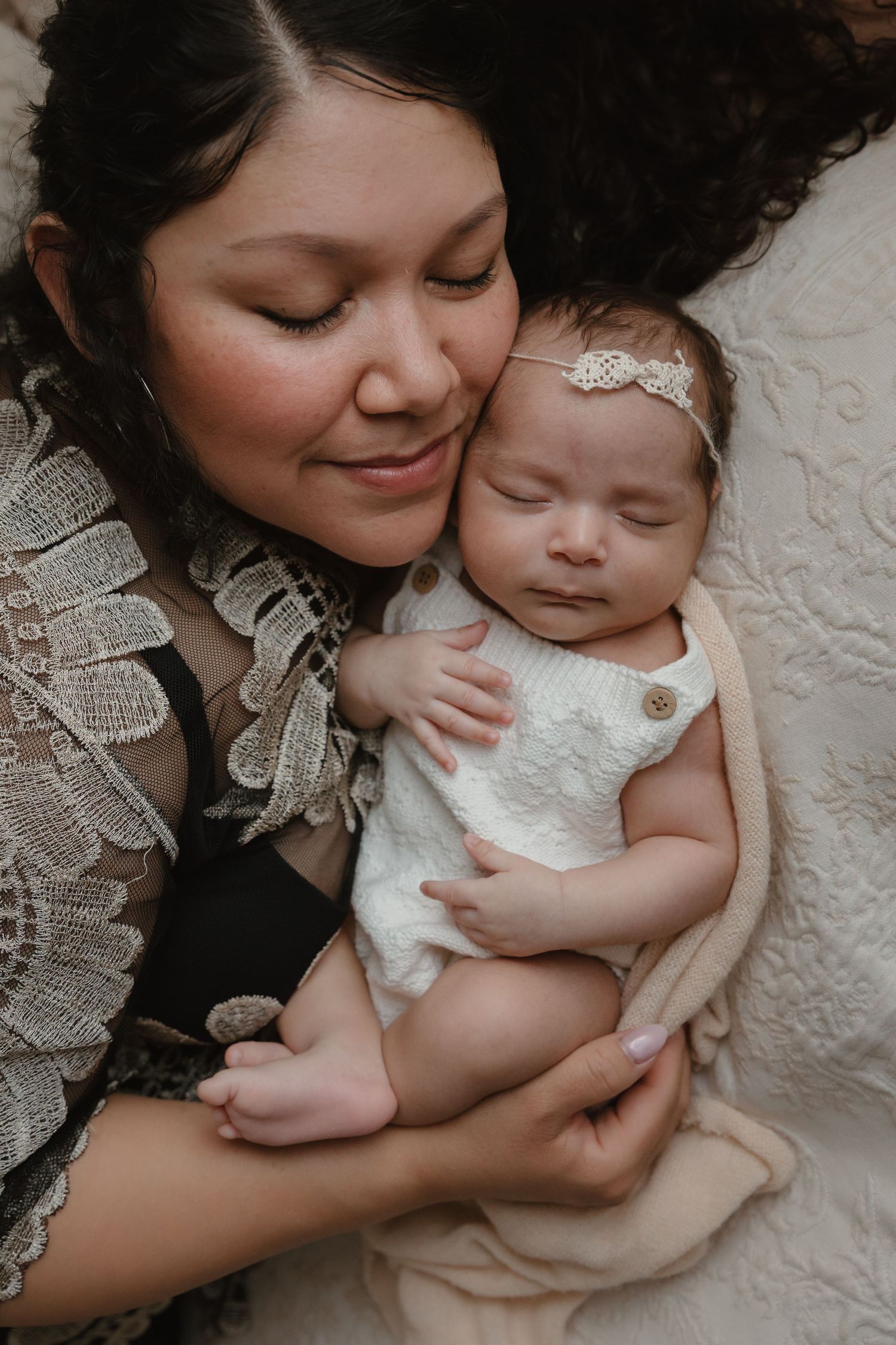 Mother snuggling baby during natural, connection focused newborn photography session in Tyler Texas