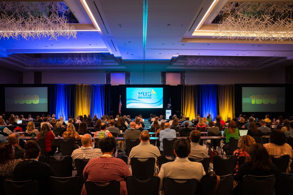 Large audience seated at HUG National Conference in ballroom.