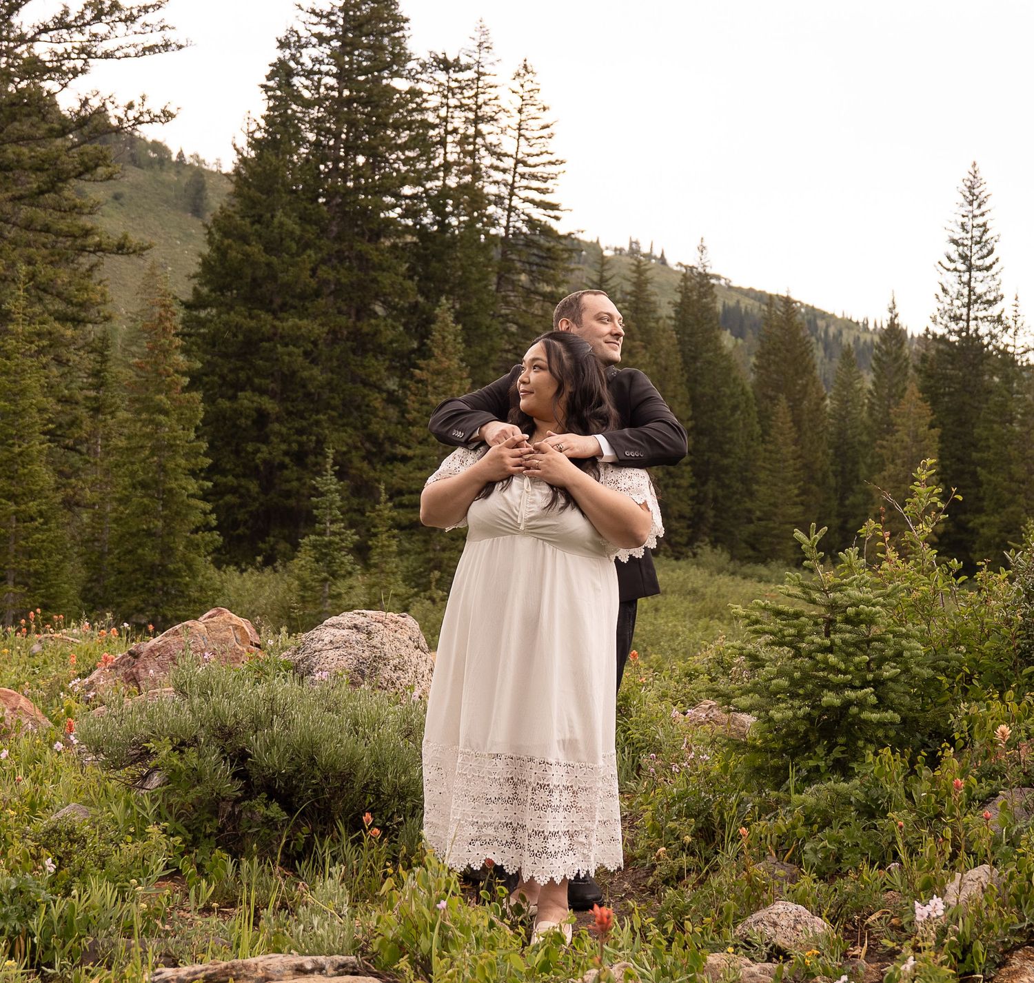 Couple admiring tall forest during their engagement session in logan canyon