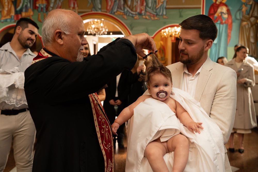 Orthodox Christening photographer documenting a traditional church baptism