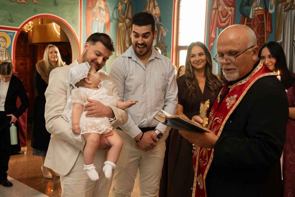 Parents and baby during an Orthodox Christening ceremony in Wollongong NSW