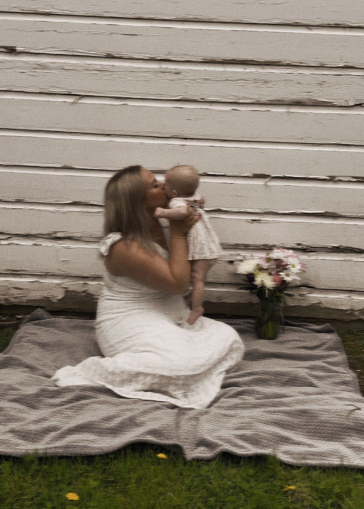 Mother kissing her baby during an outdoor motherhood photography session