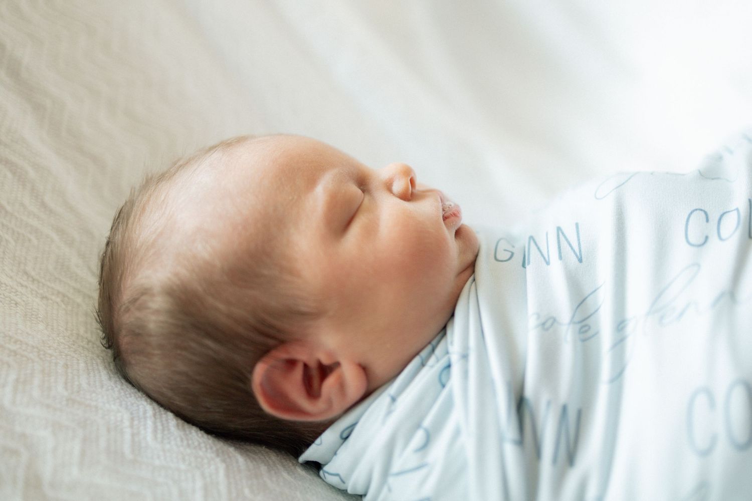 Peaceful newborn baby sleeping soundly at University of Tennessee Medical Center for a Fresh 48 Session.