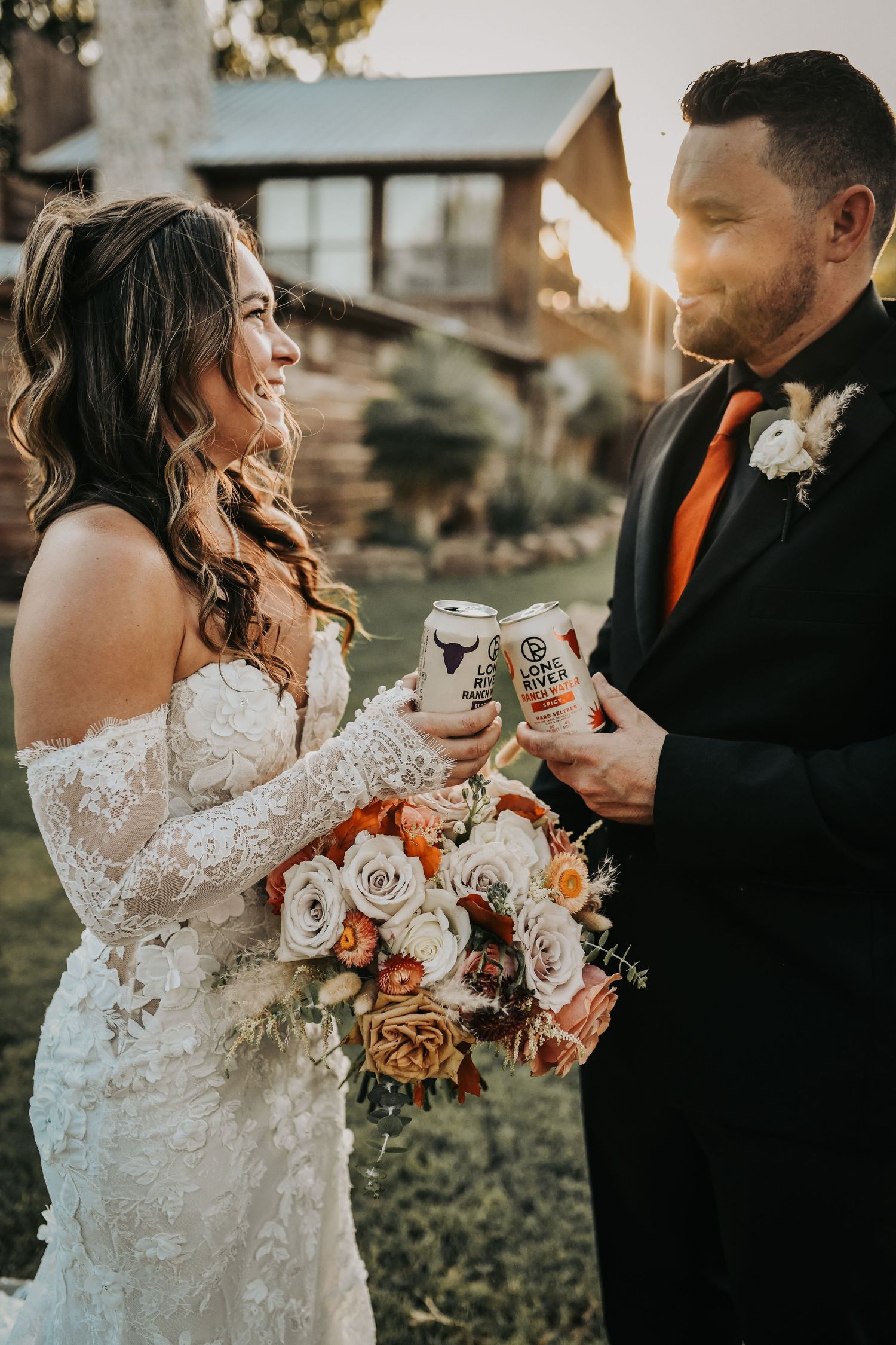 Newlyweds posing together during their rustic ranch wedding