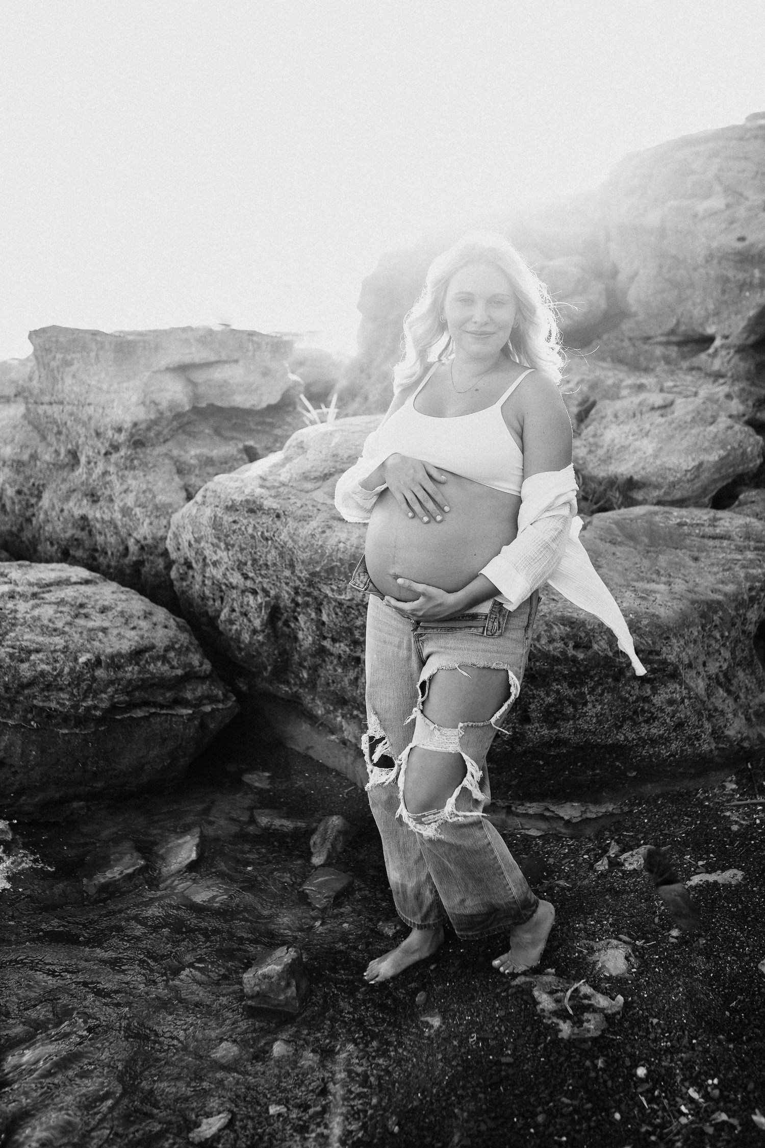 Dad holding expecting mom during their Lake Grapevine maternity photography session