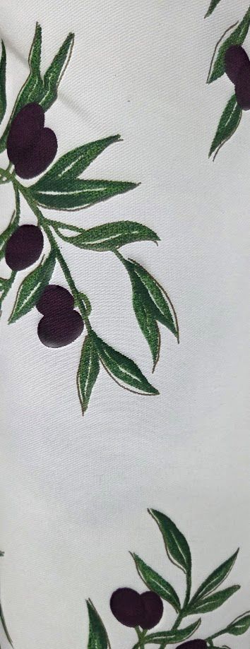 White fabric with green olive branch print pattern featuring dark purple olives and leaves.