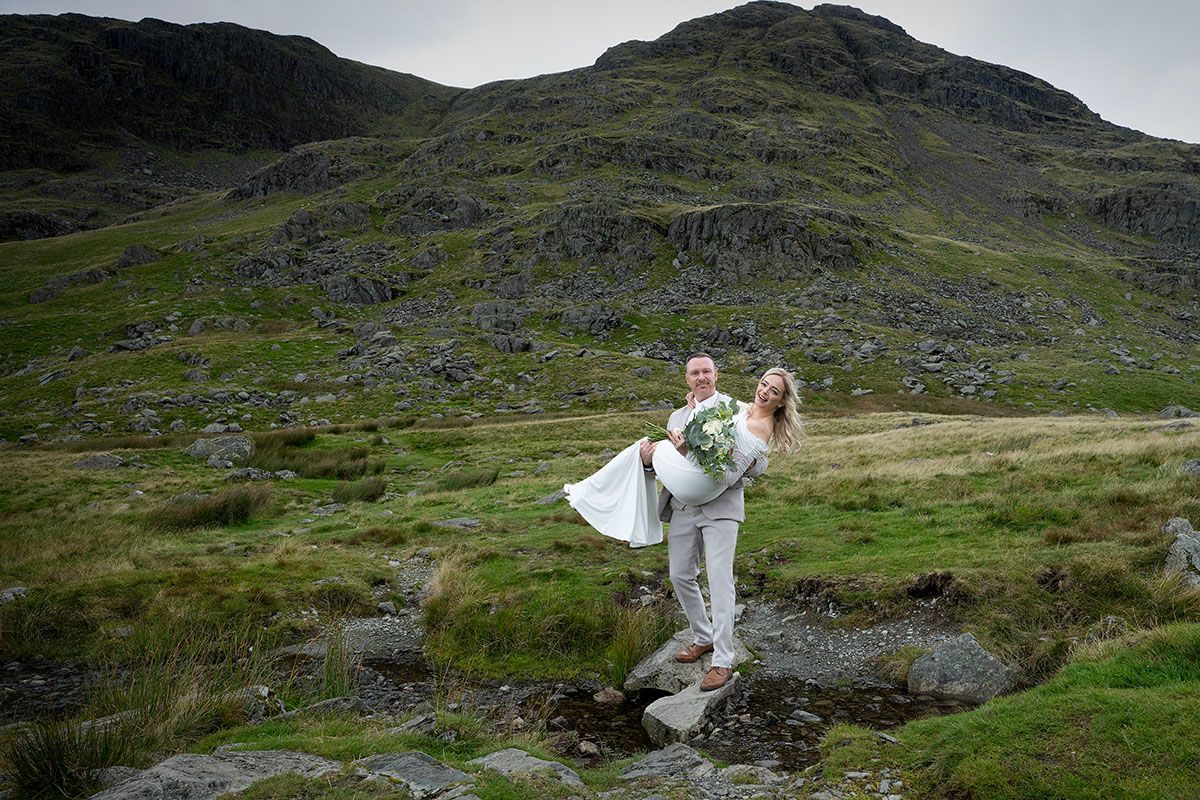 Groom lifting bride whilst on their Lake District elopement wedding