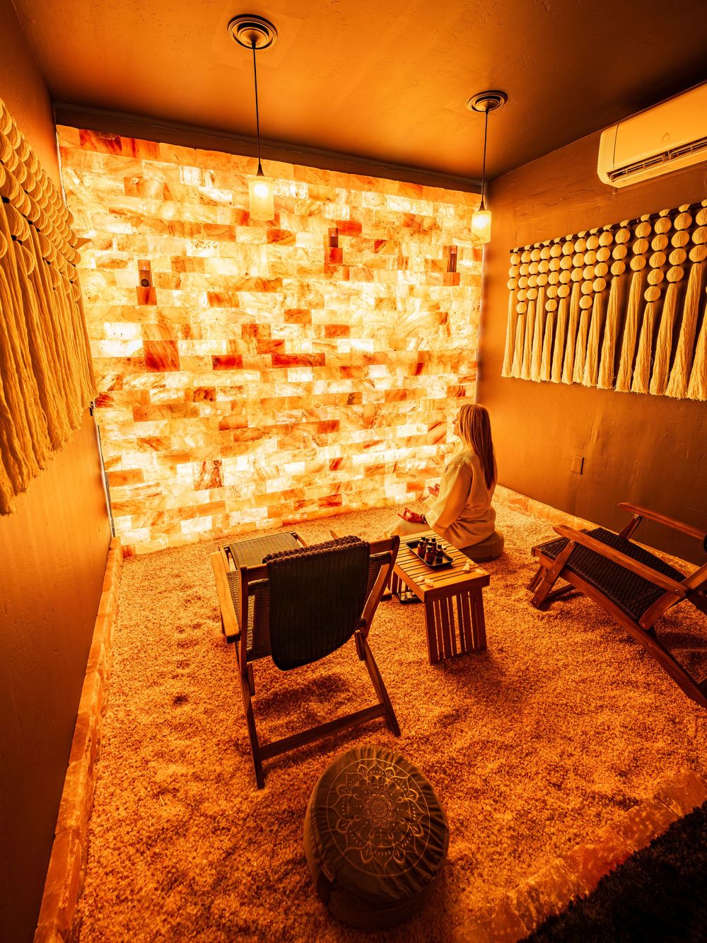 Woman meditating in the salt room of a luxury hotel, The Southwest Inn in Sedona, AZ.