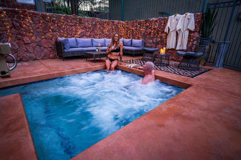 A couple soaking in the hot tub at a luxury hotel, The Southwest Inn in Sedona, AZ