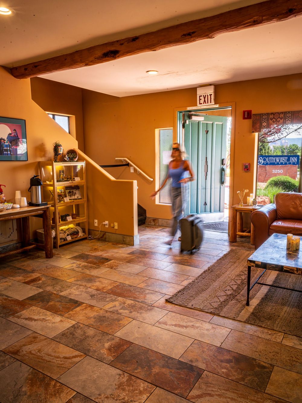 Long exposure of a woman walking in with luggage at a luxury hotel, The Southwest Inn in Sedona, AZ.