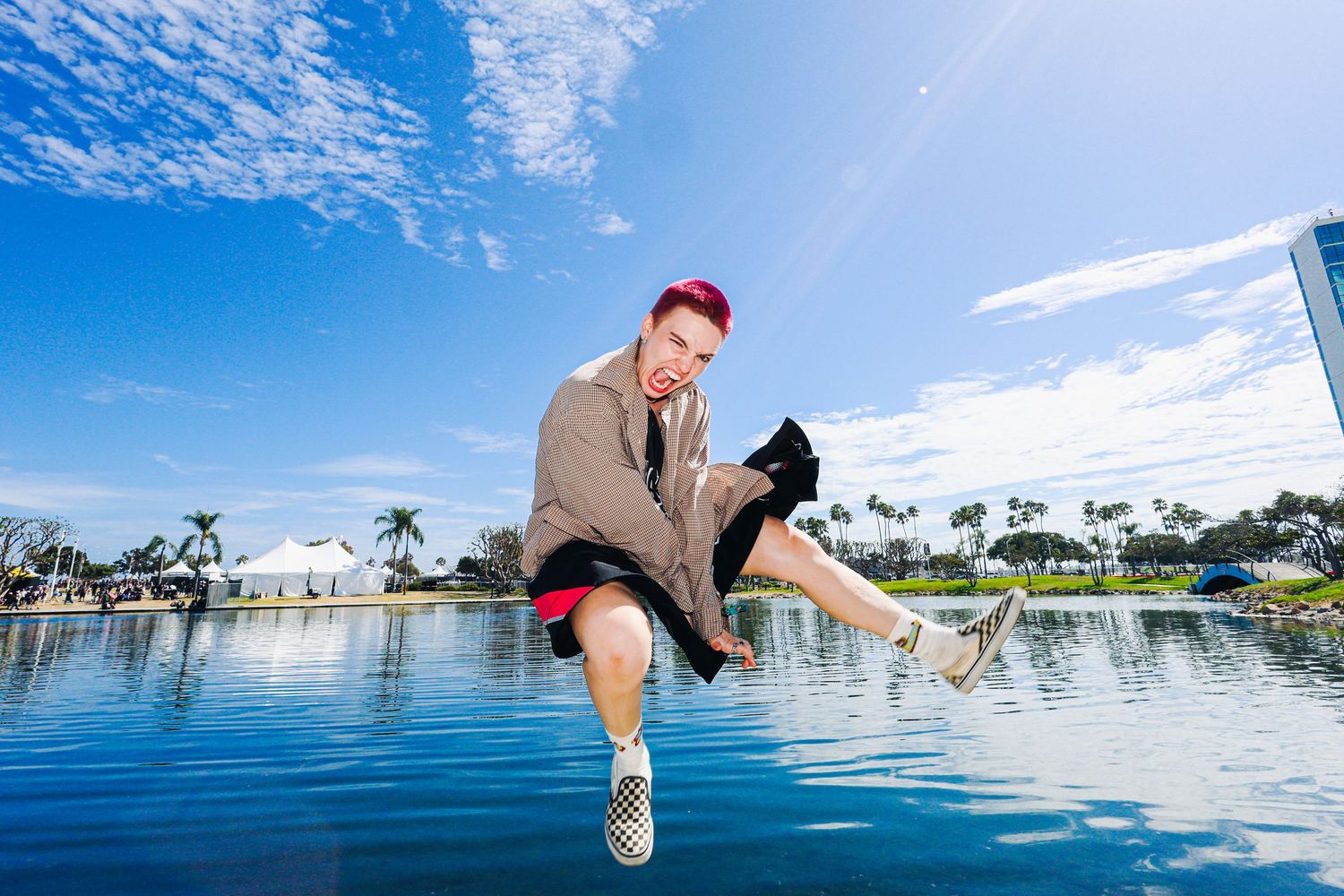 Addie Addie Addie at Vans Warped Tour 2026 in Long Beach, CA. Addie jumping in the air with a lake behind.