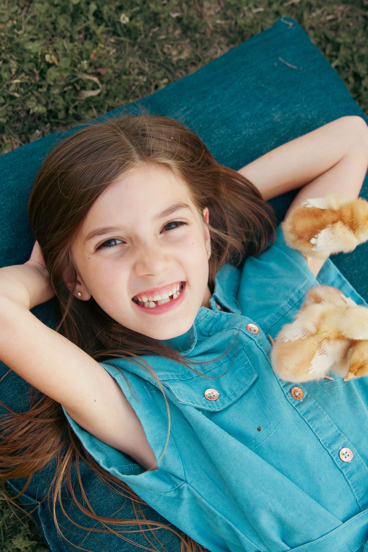 a young girl with yellow chicks during a spring childhood session in Blytheville Arkansas