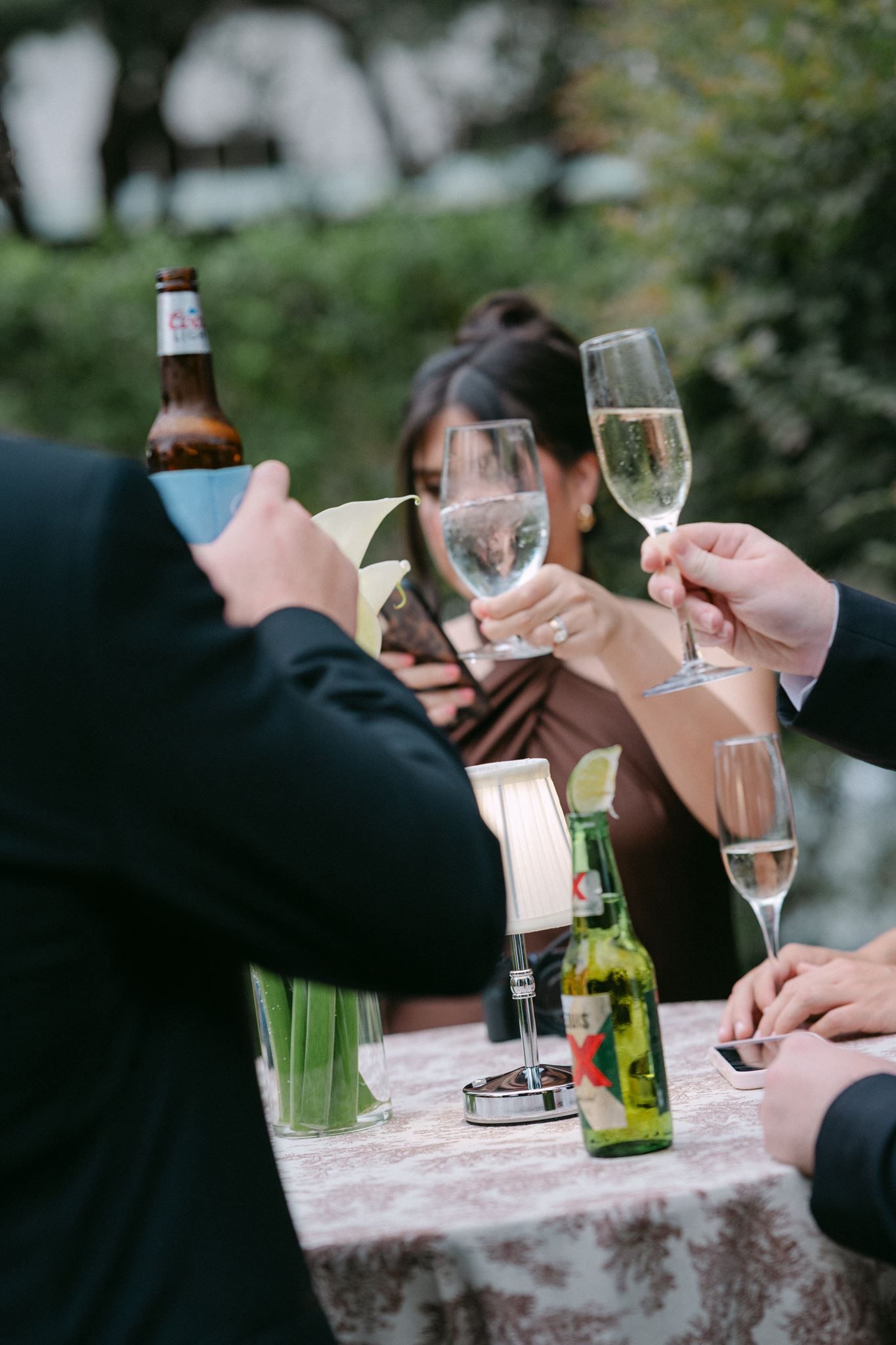 Close up of people cheering their champagne glasses.