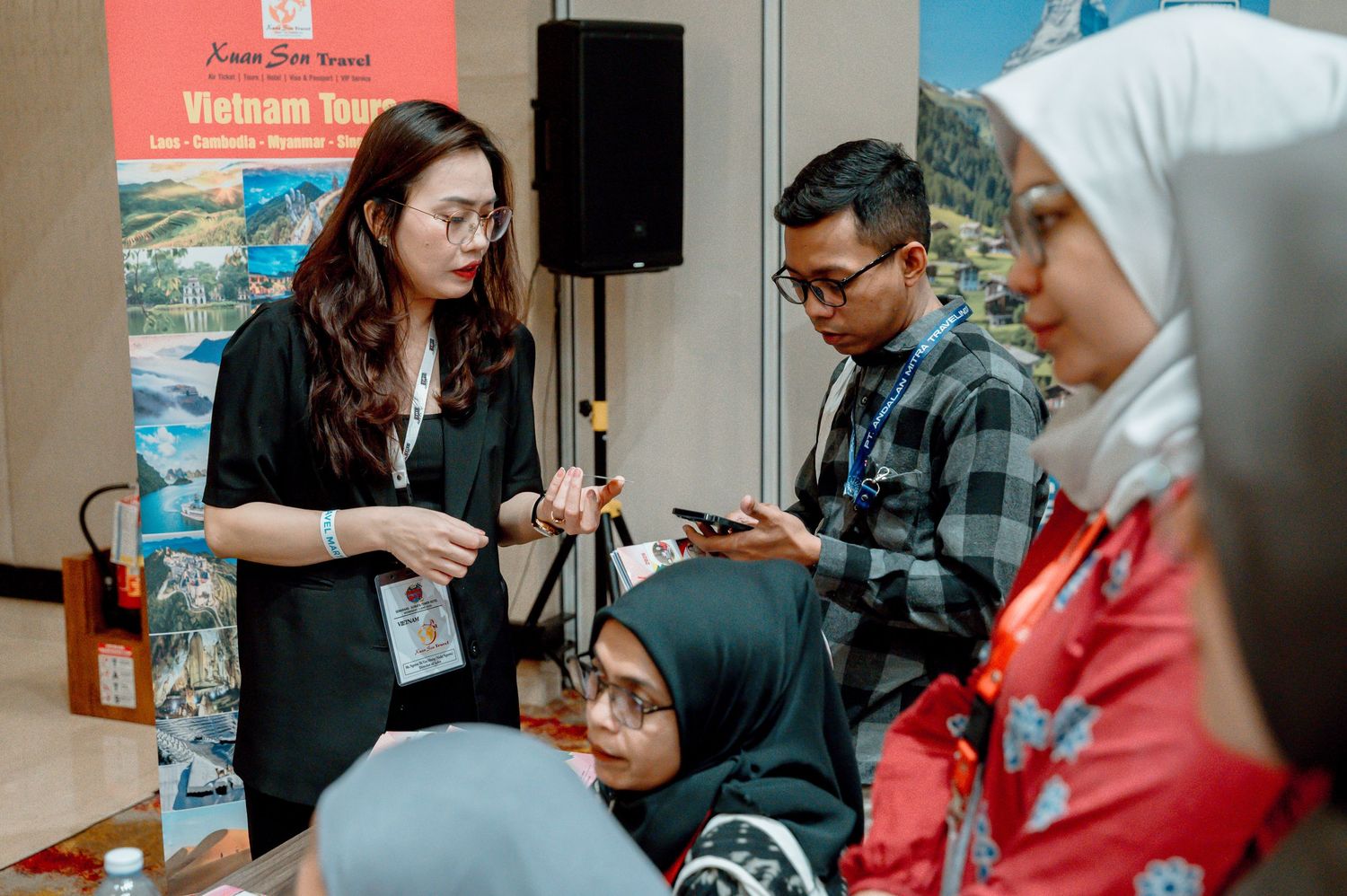 A woman presents Vietnam tourism information to a group of attendees at a travel industry conference event.
