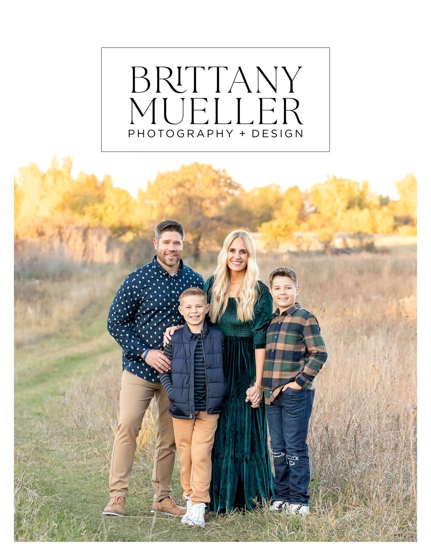 Family of four posing outdoors in a golden field for Brittany Mueller Photography and Design portrait session.