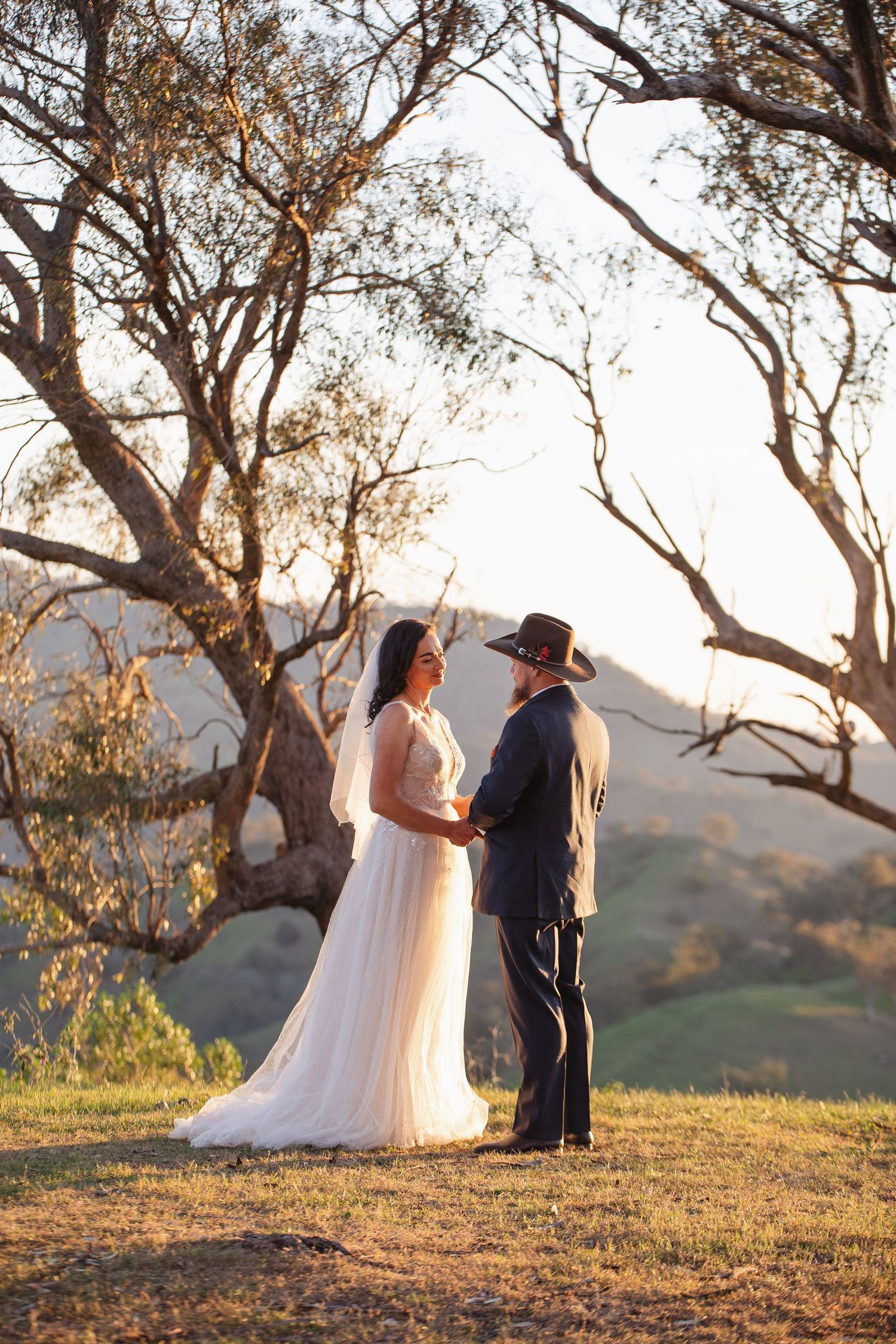 Kylie and Jono sharing private wedding vows on a mountaintop near Moonan Cottage