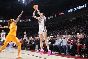 South Carolina basketball player wearing number 31 takes a jump shot over a Tennessee defender.