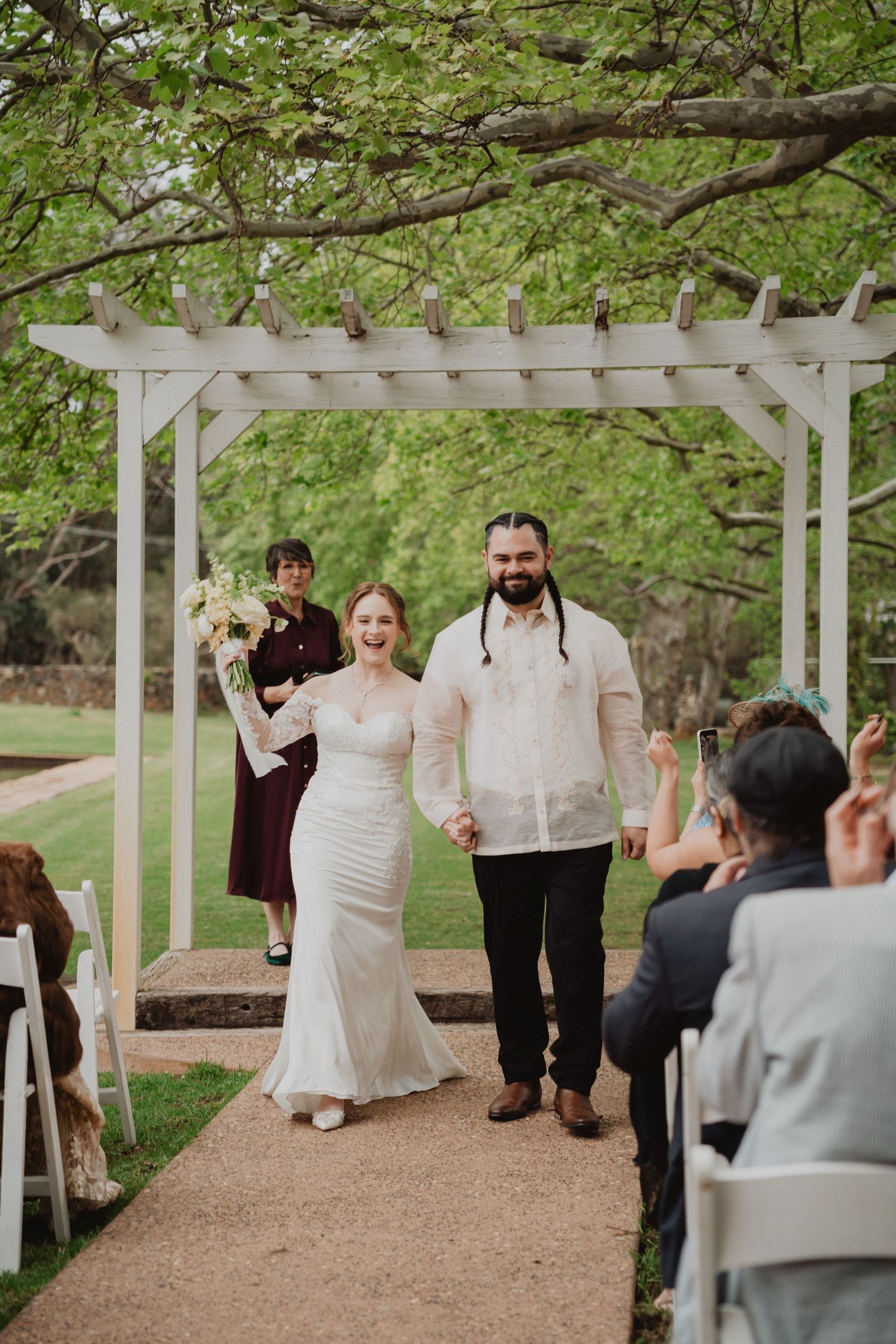 Garden wedding ceremony under a white arch, Perth wedding photographer