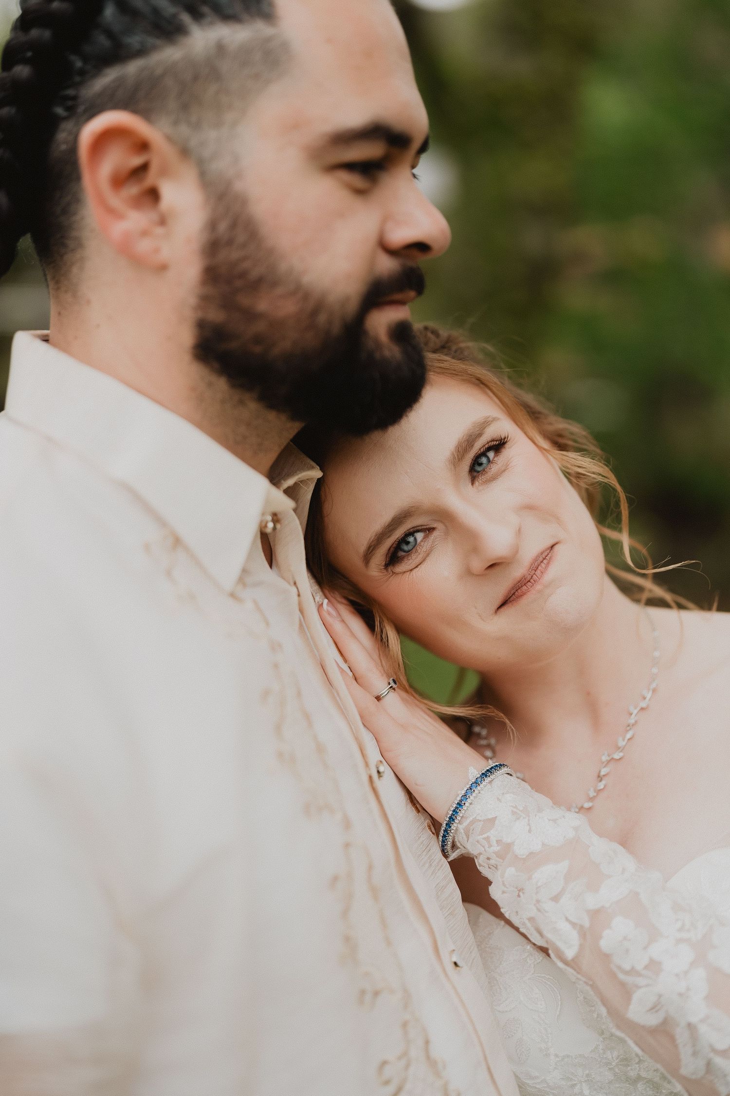 Lucy leaning on Christopher, close up wedding portrait