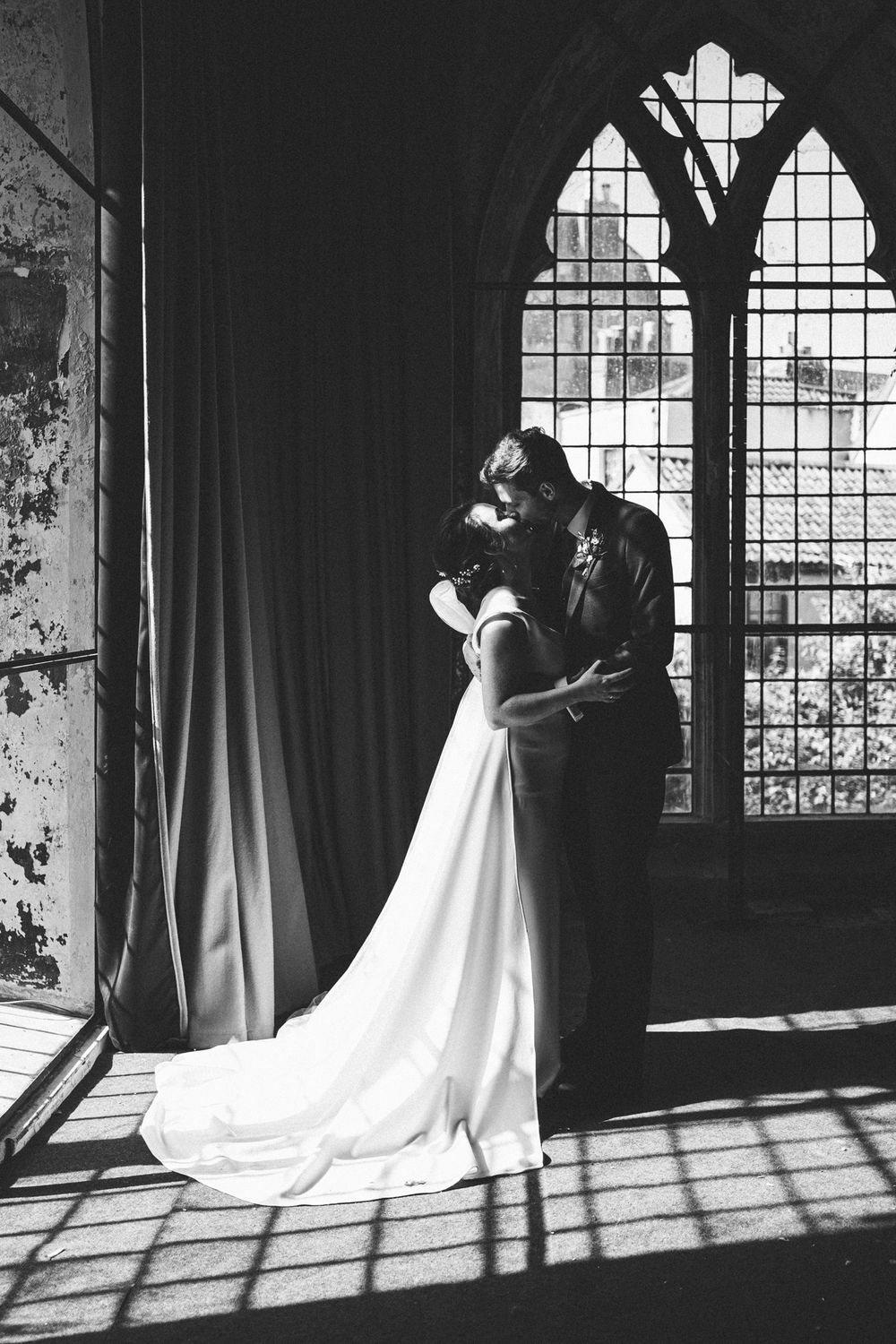 Dramatic black and white wedding portrait by a gothic window with beautiful natural light, Mount Without, Bristol
