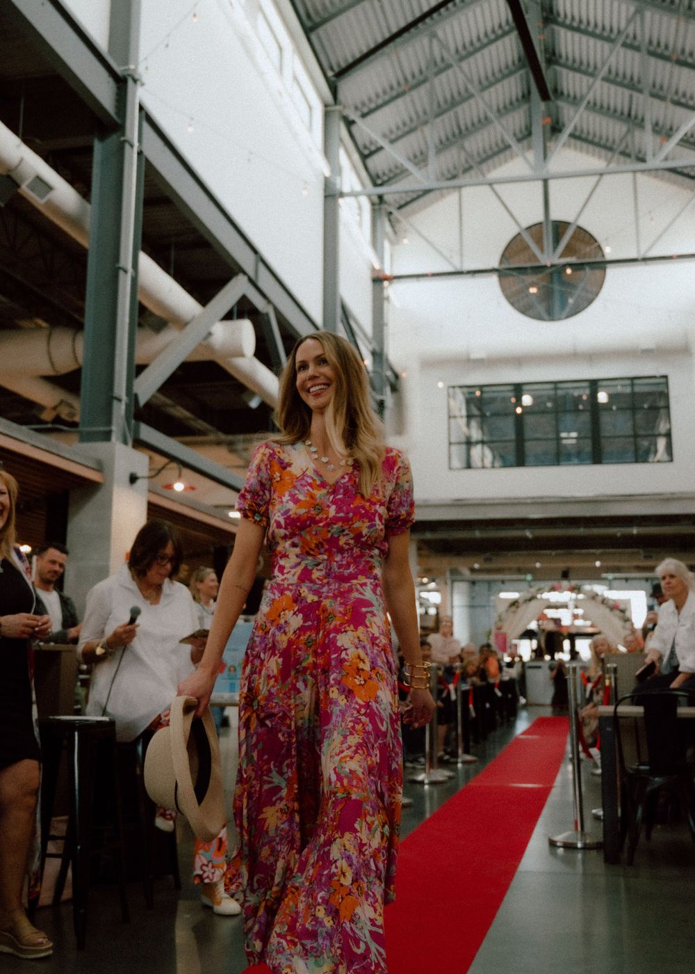 Model walking in Mother's Day fashion show at Calgary Farmers Market, showcasing seasonal styles