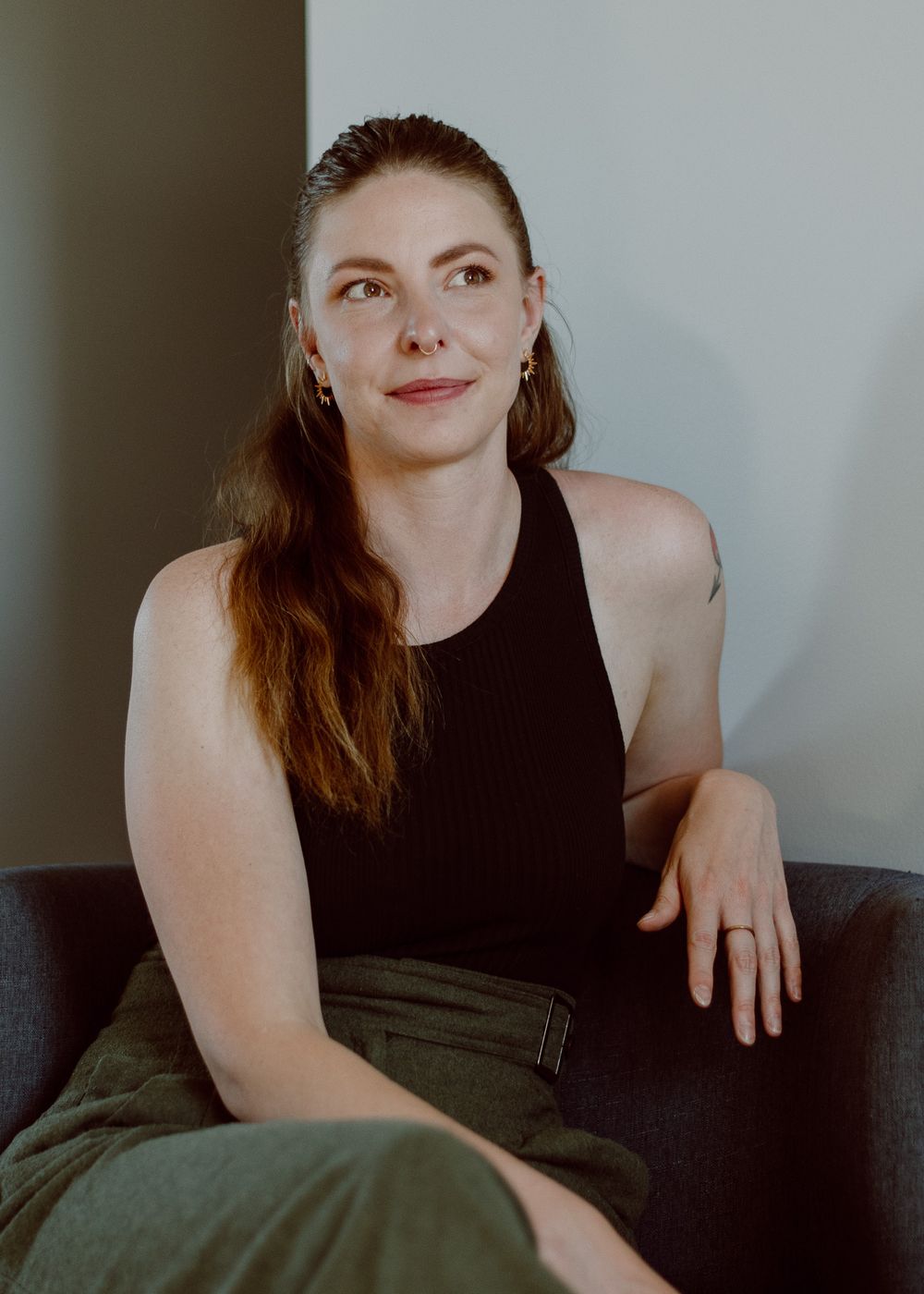 Headshot of a massage therapist with branding colors in green tones, conveying a calming and professional vibe.