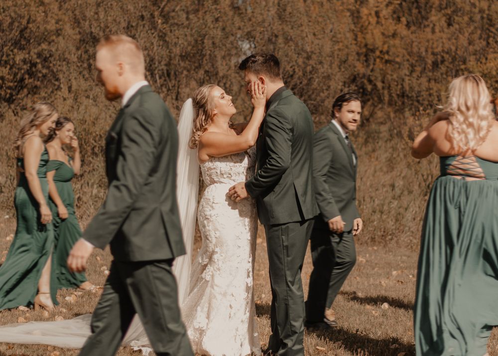 Fall wedding scene with bride, groom, and bridal party in stylish motion blur for a trendy effect.