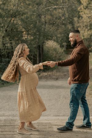 A dancing moment captured on a wooden boardwalk during autumn.