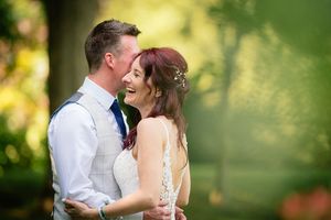 Romantic golden hour wedding portraits in a dreamy garden setting.