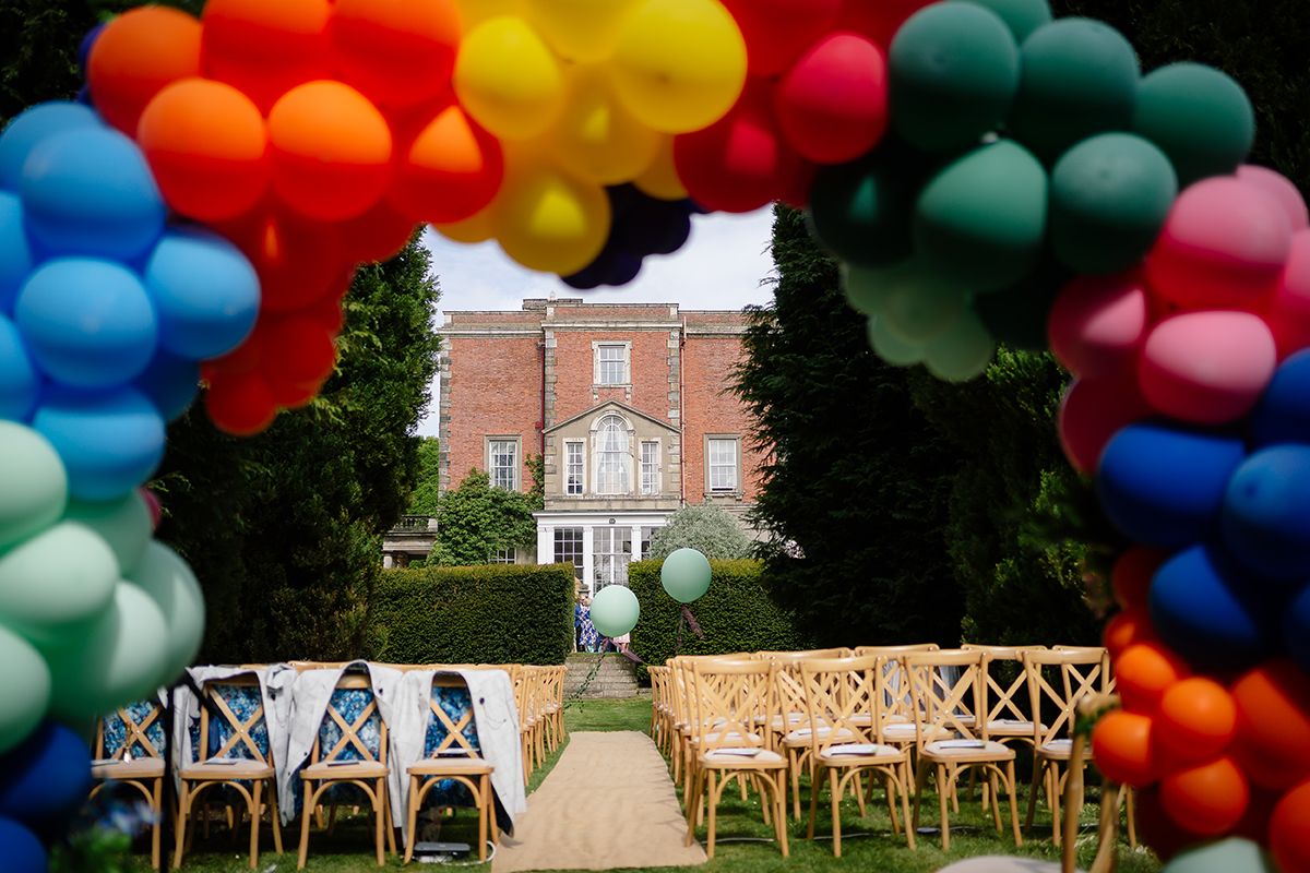 Colorful balloon arch installation creating vibrant entrance pathway for outdoor event.