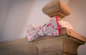 Closeup sequence showing a book page being turned, revealing floral fabric peeking through the edges.