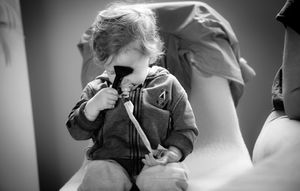 Black and white photo series showing intimate moments of a couple dancing together in elegant formal attire.